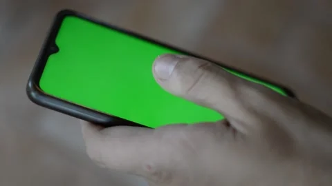 Man's hand using iphone with green screen Stock Footage 200821078