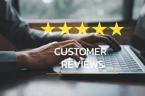Man's hand using a laptop with a 5-star popup for customer service satisfaction Stock Photos