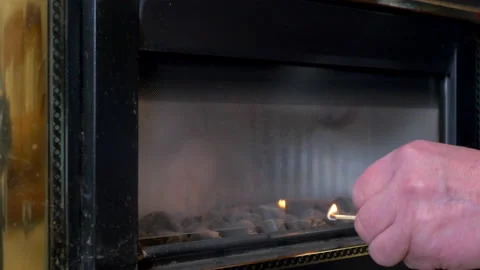 Man's hand using a matchstick to light an old gas fire. Stock-Footage 170501968