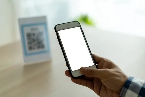 The man's hand is using a mobile phone to scan QR code. The man is scanning t Foto stock