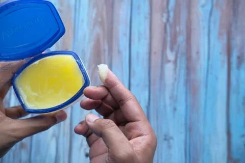 Man's hand using petroleum jelly top down Stock Photos