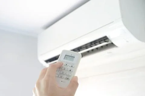 Man's hand using remote control open The air conditioner is cooled to 25 degr Foto stock