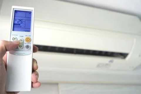 Man's hand using remote control open The air conditioner is cooled to 25 degr Stock Photos