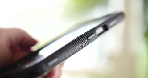Man's hand using smartphone side view outdoors texting surfing the internet Stock Footage 205955767