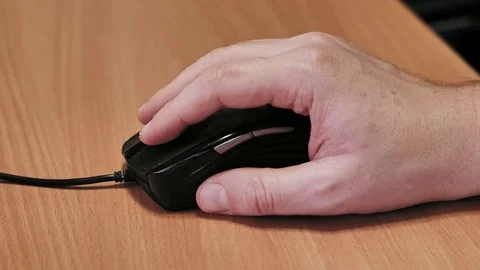 Man's hand using a wired computer mouse Stock Footage 85402380