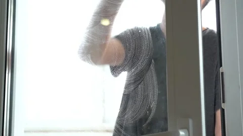 A man's hand washes the window with a rag. Housework, cleaning. Stock Footage 153258690