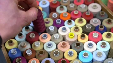 A man's hand with a watch selects the thread Stock Footage 86053072