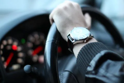 Mans hand on a wheel	 Stock Photos