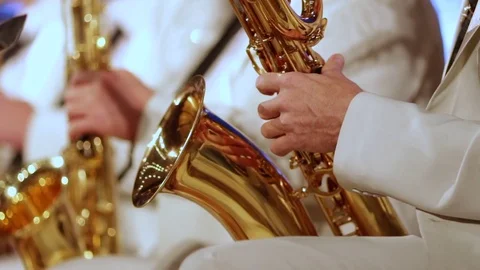 A man's hand in a white suit on a gold saxophone in a jazz band. Close-up. Shall Stock Footage 82332864
