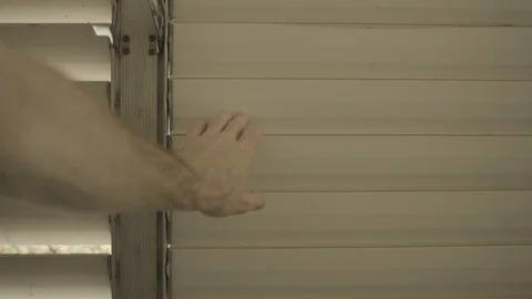 Man’s hand on the window opening the shutters . Stock-Footage 129115412