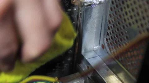 A man's hand wipes the inside of a computer system unit from dust. Stock Footage 169405695