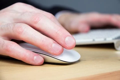 Man's hand with wireless computer mouse Stock Photos