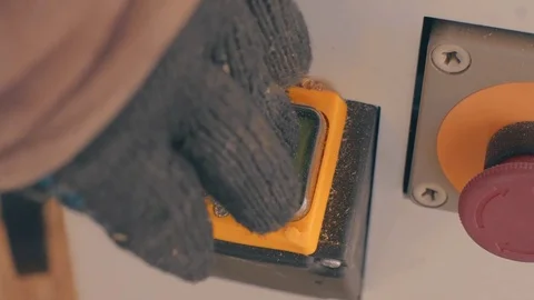 Man's hand in a working glove switching off a machine Video stock 72776032