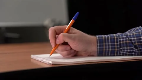 Man's hand wright the text on the paper. Create a contract in the office Stock Footage 153526644