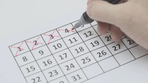Man's hand write down day from 1 to 8 on paper calendar Stock-Footage 265878811