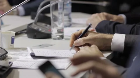 Man's hand writes notes in a very important point. International Forum, a busine Video stock 64904395