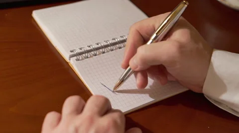Man's hand writing happy on the notebook   Stock Footage 62086391