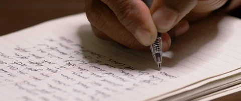 Mans hand writing a letter at the table Stock Footage 103412029