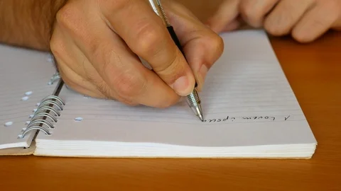 Man's hand writing a note list in a lined notebook Stock Footage 119152034