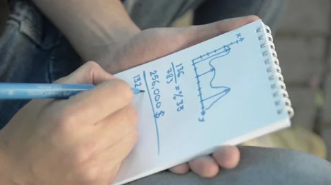 Man's hand writing in notebook numbers. Stock Footage 51754899