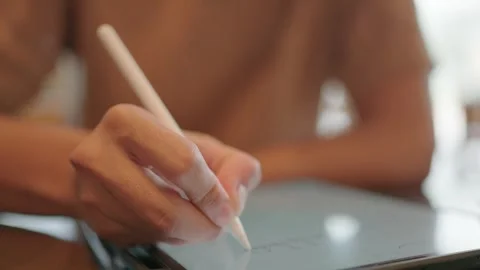 Man's hand writing on tablet page sitting with coffee Stock Footage 251974027