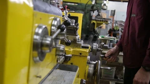 Mans hands adjusting lathe machine during sharpening metal rods Stock Footage 125748045