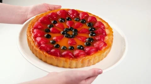 The man's hands are holding a dish of cheesecake.  Stock Footage 282963147