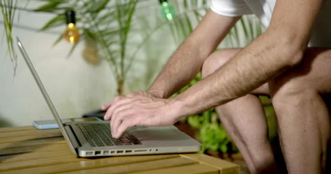 A man's hands are seen typing on a laptop keyboard, 库存影片 336313809