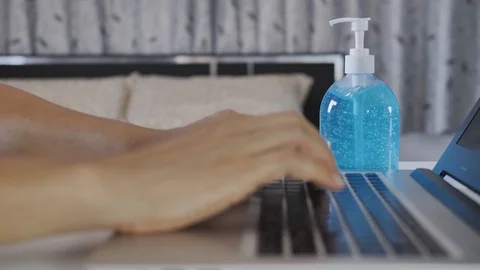 A man's hands are typing on a computer in the bedroom. Stock Footage 129597157