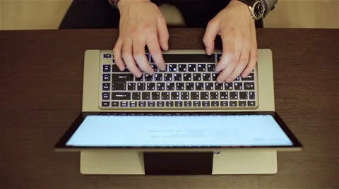 Man's hands are typing on the keyboard of the laptop at the office. Stock Footage 62927589