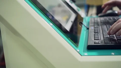 Man's hands are typing on the keyboard of the machine control panel. Video stock 126326850