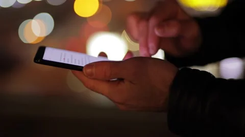 Man's hands are typing a message on the phone Stock Footage 144210091
