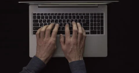 The man's hands are working on the laptop keyboard. Top view of typing text. Stock Footage 149889137