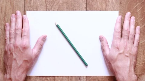 Man's hands beside blank sheet Видео 94440359