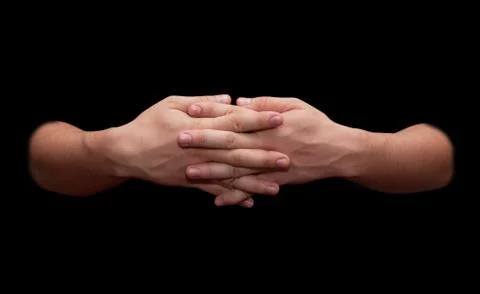 Man's hands on a black background Stock Photos