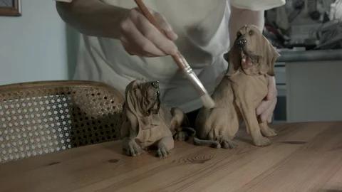 Mans hands brushing ceramic hounddogs Not B&amp;W Vidéo 72938181