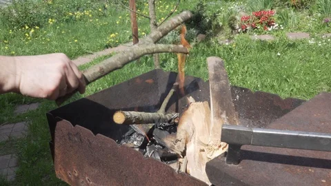 Man's hands building fire in BBQ Stock Footage 89846774