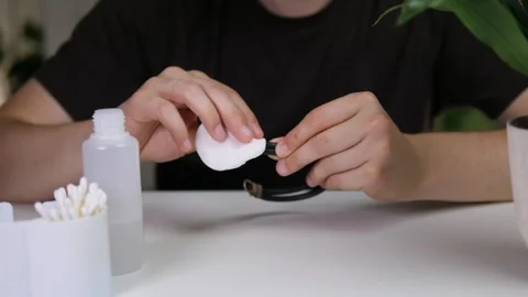 A mans hands carefully clean an elegant leather bracelet with a precious metal 스톡 동영상 318947358