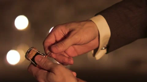 Man's hands carefully open a bottle of champagne. Stock-Footage 42820186