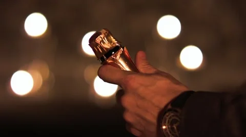 Man's hands carefully open a bottle of champagne. Stock Footage 42820237