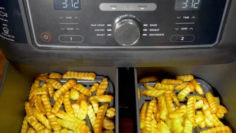 Man’s hands checking fries / chips, cooking in an air fryer. Stock-Footage 228563626