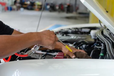 A man's hands, checking machine of automobile. Stock Photos