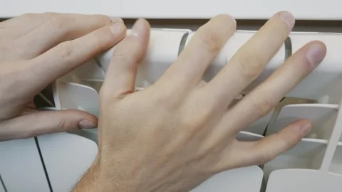 Mans Hands Checking The Temperature Of A Modern White Home Radiator. Stock Footage 329134821