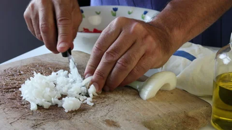Man's hands chopping a spring onion on a wooden board. Stock Footage 195950169