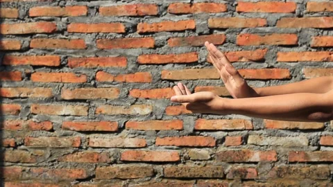 Man's hands clapping against brick wall background Stock Footage 282228290