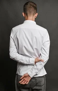 A man's hands clasped behind his back. get a grip. Stock Photos