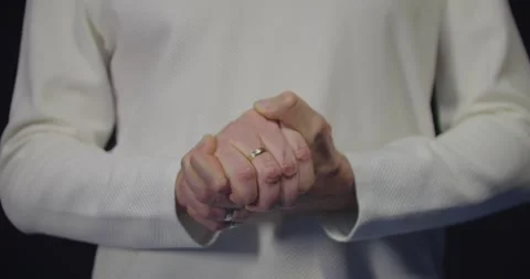 Man's hands clasped together. A man in white holding his hands together. Stock Footage 305060067