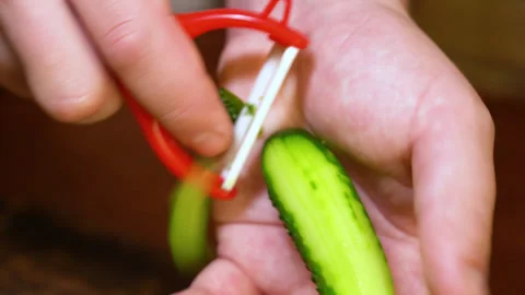 Man's hands clean fresh cucumber on cutting board Stock Footage 254593677