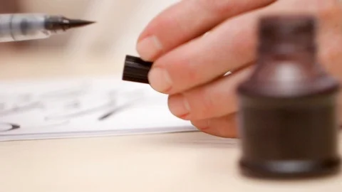 Mans hands close brush pen then put pen down on beige desk. Close shot. Front Stock Footage 104556408