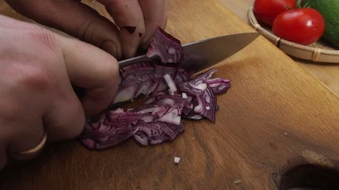 Man's hands close up cutting onions on a cutting Board made of wood Stock Footage 129807201